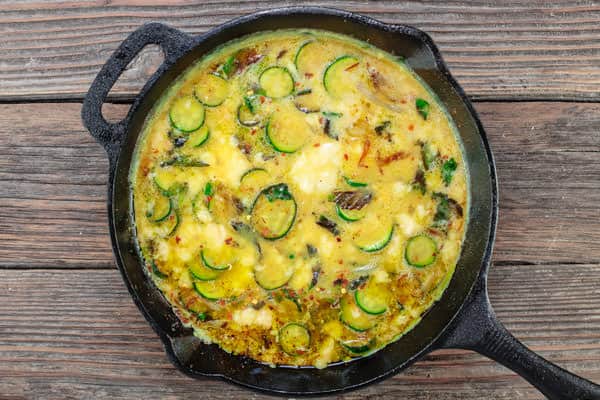 zucchini and onions added into the egg mixture