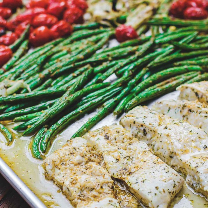 One Pan Baked Halibut Recipe | The Mediterranean Dish. Halibut fillet with green beans and cherry tomatoes baked in a delicious Mediterranean sauce with garlic, olive oil and lemon juice. Comes together in less than 30 mins! See the step-by-step on The Mediterranean Dish.