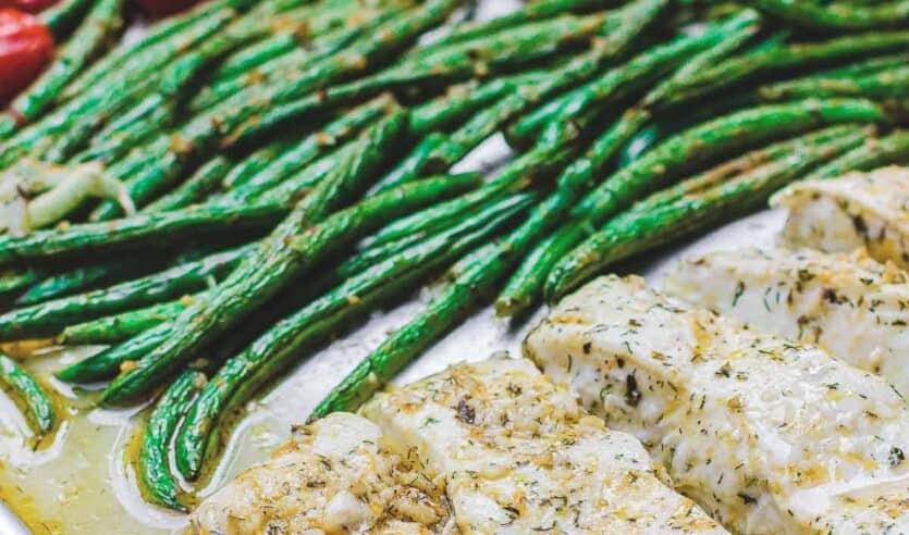 One Pan Baked Halibut Recipe | The Mediterranean Dish. Halibut fillet with green beans and cherry tomatoes baked in a delicious Mediterranean sauce with garlic, olive oil and lemon juice. Comes together in less than 30 mins! See the step-by-step on The Mediterranean Dish.