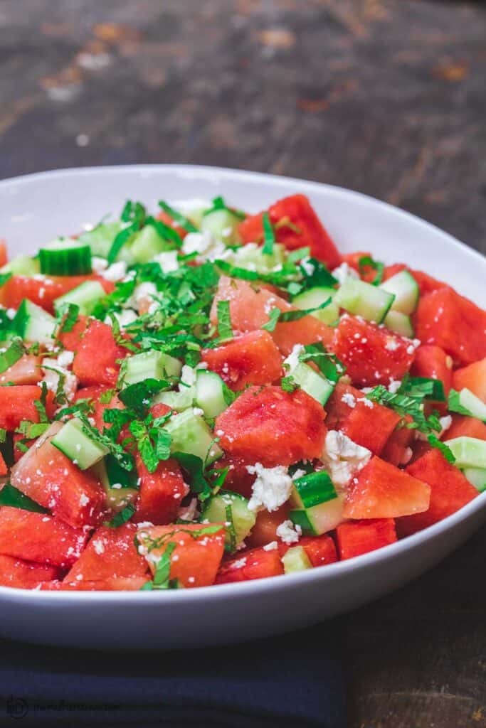 Mediterranean Watermelon Salad Recipe | The Mediterranean Dish. A light and fresh watermelon salad with cucumbers, feta cheese and fresh herbs. All dressed in a honey vinaigrette.