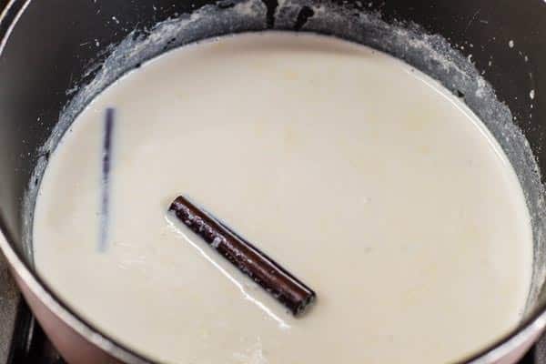 Milk, half and half, cinnamon sticks and cloves combined in a medium saucepan.