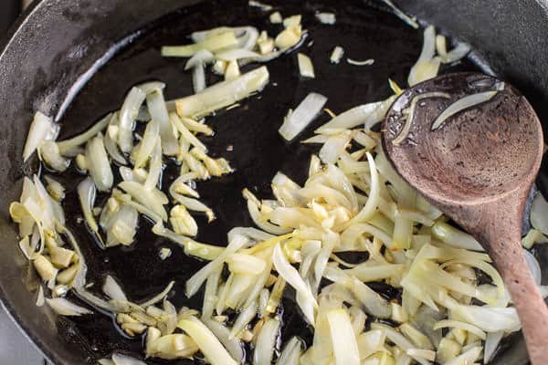 Onions being cooked in a pan