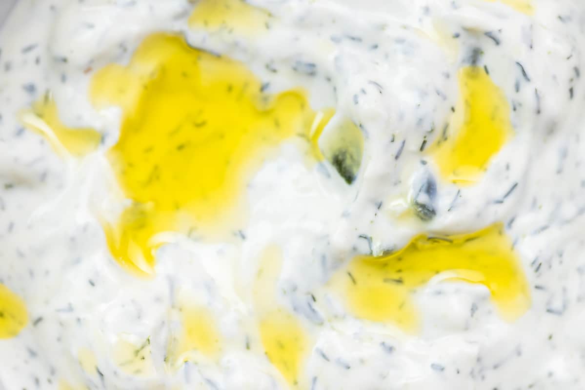Close-up of Greek tzatziki sauce with a drizzle of olive oil on top