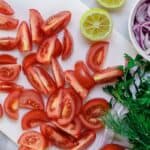 Mediterranean Fresh Herb Tomato Salad | The Mediterranean Dish. Tomatoes and red onions with fresh parsley and cilantro, doused in citrus and olive oil. Vegan. Gluten-free. Click the image for the recipe and visit TheMediterraneanDish.com for more healthy recipes!