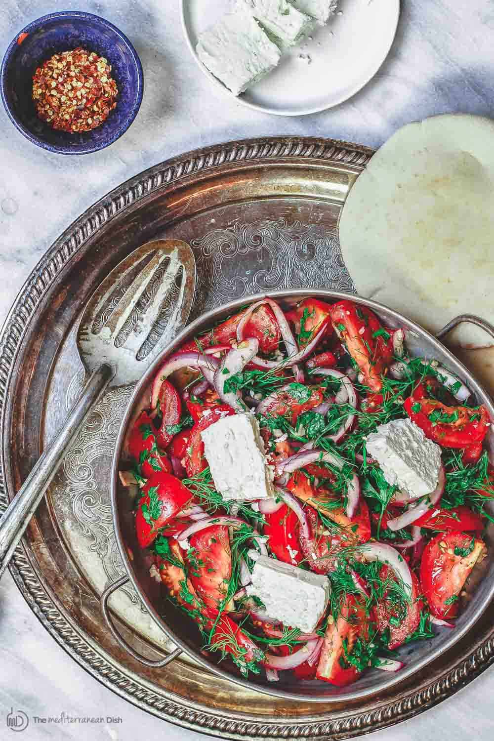 Mediterranean Tomato salad with onions, fresh herbs and feta. Served with pita bread