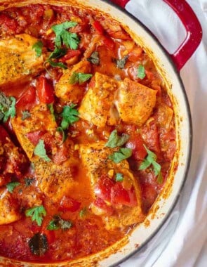 Fish fillet cooked with tomato sauce and served shakshuka style in a braiser