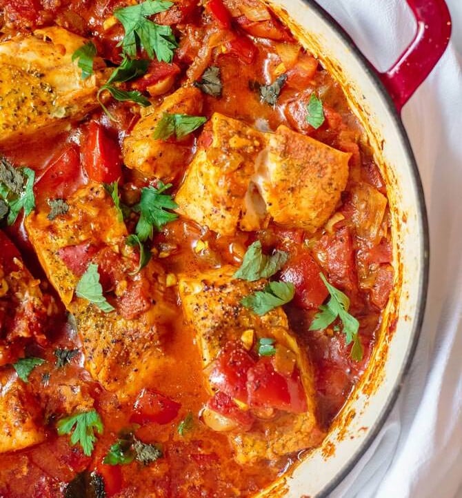 Fish fillet cooked with tomato sauce and served shakshuka style in a braiser