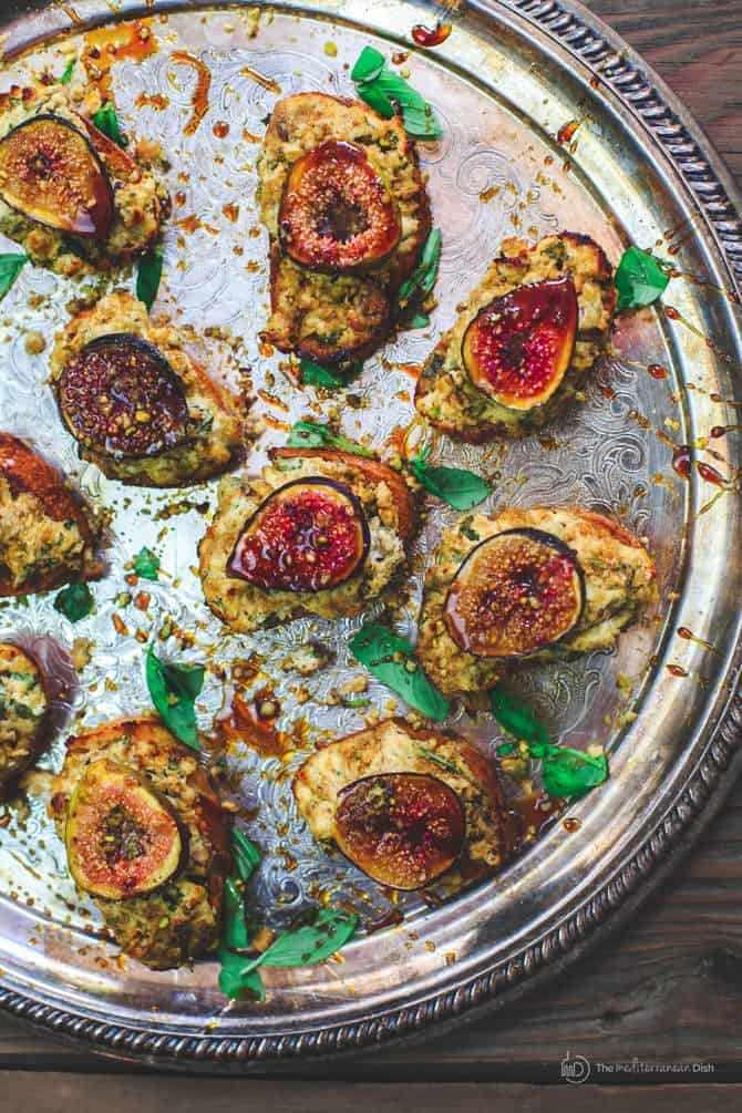 Platter containing Fig Pistachio Goat Cheese Crostinis ready to be served