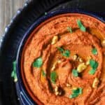 Muhamara Recipe (Roasted Red Pepper Dip) | The Mediterranean Dish. A hearty vegan dip with roasted red peppers and walnuts with a splash of pomegranate molasses and Mediterranean spices. See the step-by-step tutorial on TheMediterraneanDish.com