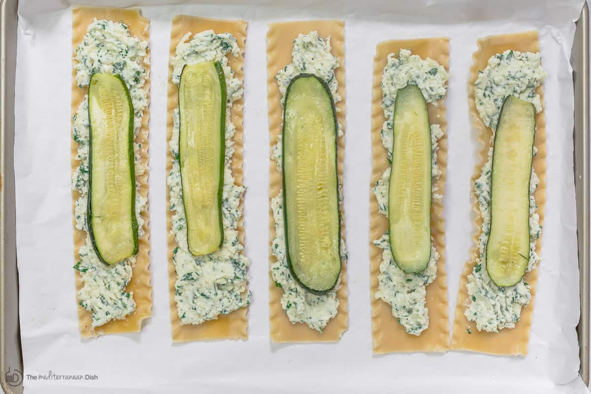 Lasagna noodles with a filling spread and zucchini on top