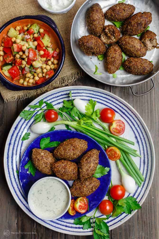 Kibbeh served with a side of mixed vegetables and Greek dip