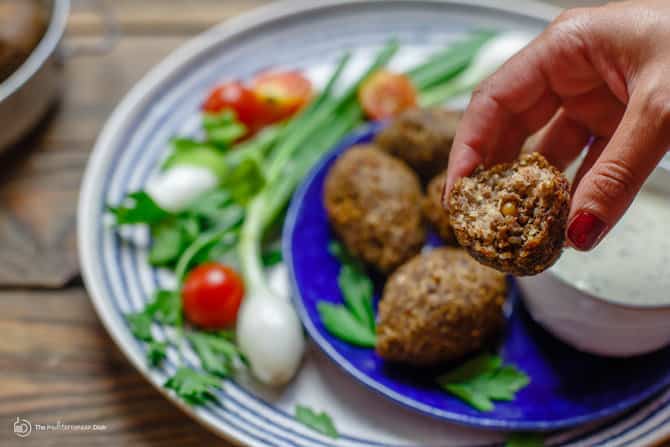 Piece of Kibbeh broken in half to see stuffed contents