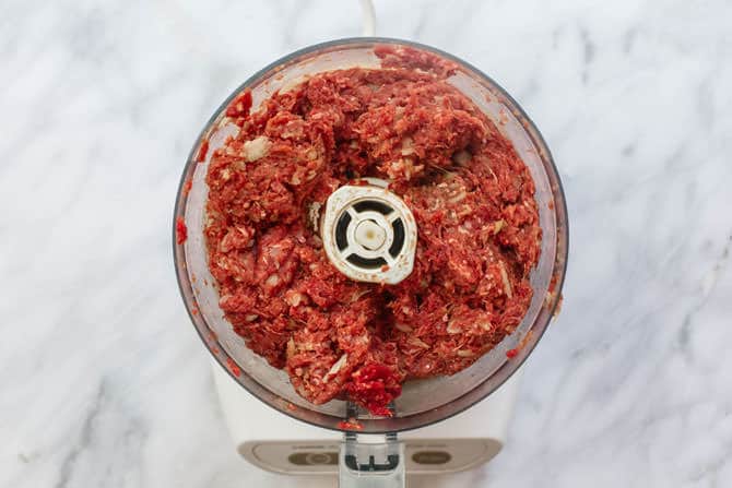 Ground meat with spices added to a food processor