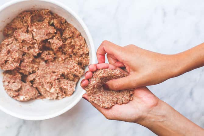 Kibbeh dough formed into shells using hands