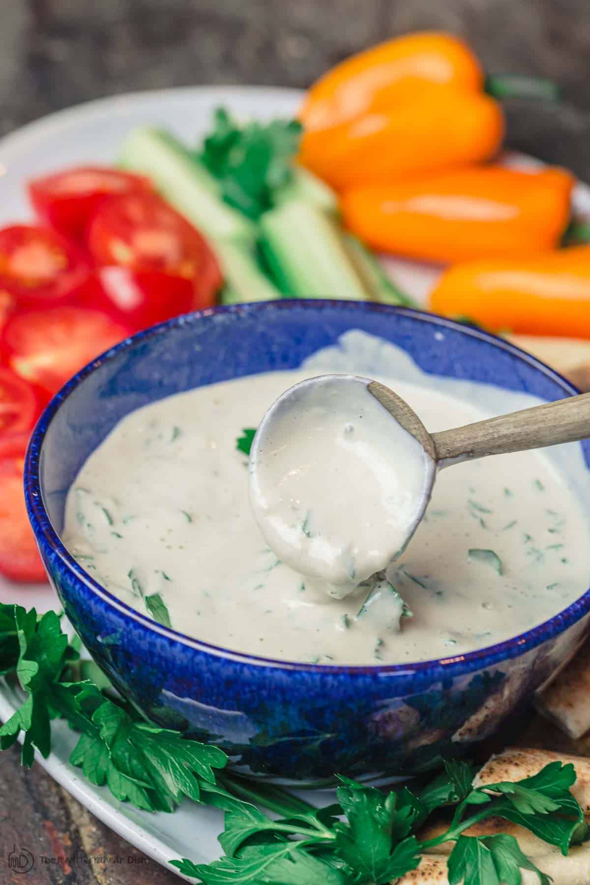 Tahini Sauce Recipe (How to Make Tahini) | The Mediterranean Dish. The best Middle Eastern tahini sauce recipe with garlic, lime juice, and fresh parsley. Easy recipe. A versatile sauce for sandwiches, salad, or as a dip with your meats and fish. See it on TheMediterraneanDish.com