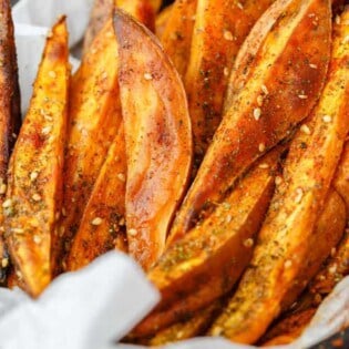 Baked Sweet Potato Fries with Za'atar | The Mediterranean Dish. Easy sweet potato fries recipe that is every bit as healthy, but tastes so indulgent! Wedges of sweet potatoes tossed in olive oil and Mediterranean spices including za'atar. A must try from TheMediterraneanDish.com