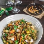 Fall Rotini Pasta Salad | The Mediterranean Dish. A simple pasta salad with charred butternut squash, burssels sprouts, spinach, and fresh parsley. A simple browned butter and olive oil sauce with shallots rounds everything together. A must-try fall salad or side holiday recipe for Thanksgiving! See the tutorial on TheMediterraneanDish.com