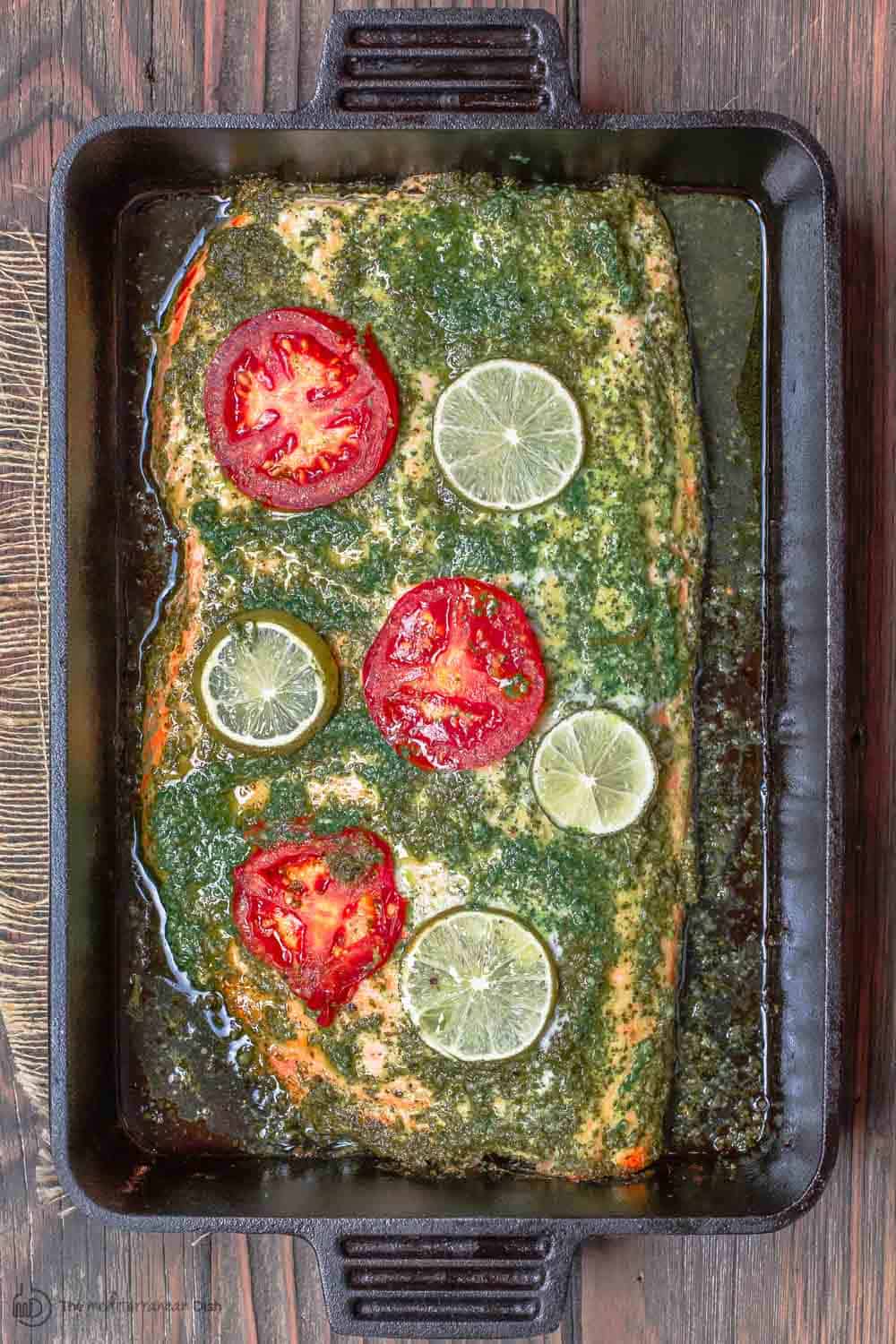 Baked Salmon Recipe with Garlic Cilantro Sauce | The Mediterranean Dish. An easy baked salmon covered in a special garlic cilantro sauce with a hint of citrus. Takes only 15 minutes start-to-finish! I make this one all the time, for weeknight dinner or a holiday dinner! See it on TheMediterraneanDish.com