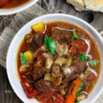 Crock Pot Italian Beef Stew Recipe | The Mediterranean Dish. This is a family favorite! Beef stew that's been slow cooked to tender perfection in a special wine broth with loads of carrots, mushrooms and aromatics. Packed with flavor from garlic, onions, and fresh herbs. Best part, it takes only 15 minutes to prep, and the crock pot does all the heavy lifting. This is the prefect beef stew! A must-try from TheMediterraneanDish.com