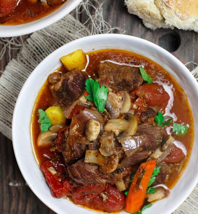Crock Pot Italian Beef Stew Recipe | The Mediterranean Dish. This is a family favorite! Beef stew that's been slow cooked to tender perfection in a special wine broth with loads of carrots, mushrooms and aromatics. Packed with flavor from garlic, onions, and fresh herbs. Best part, it takes only 15 minutes to prep, and the crock pot does all the heavy lifting. This is the prefect beef stew! A must-try from TheMediterraneanDish.com