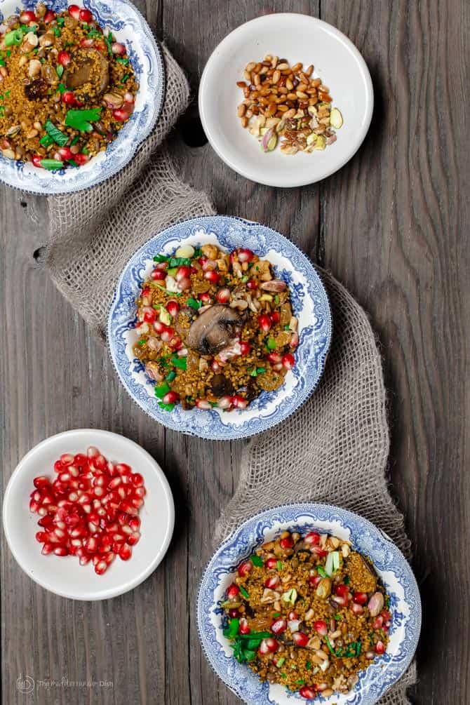 Individual servings of the jeweled couscous dish. Extra pomegranate seeds and nuts served on the side for additional texture. 