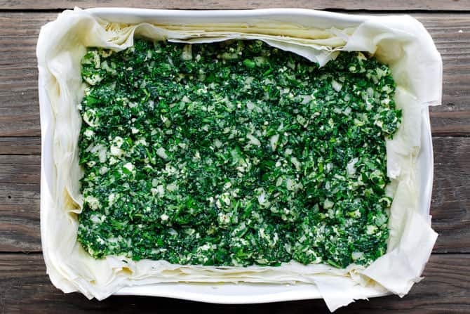 Spanakopita filling is placed