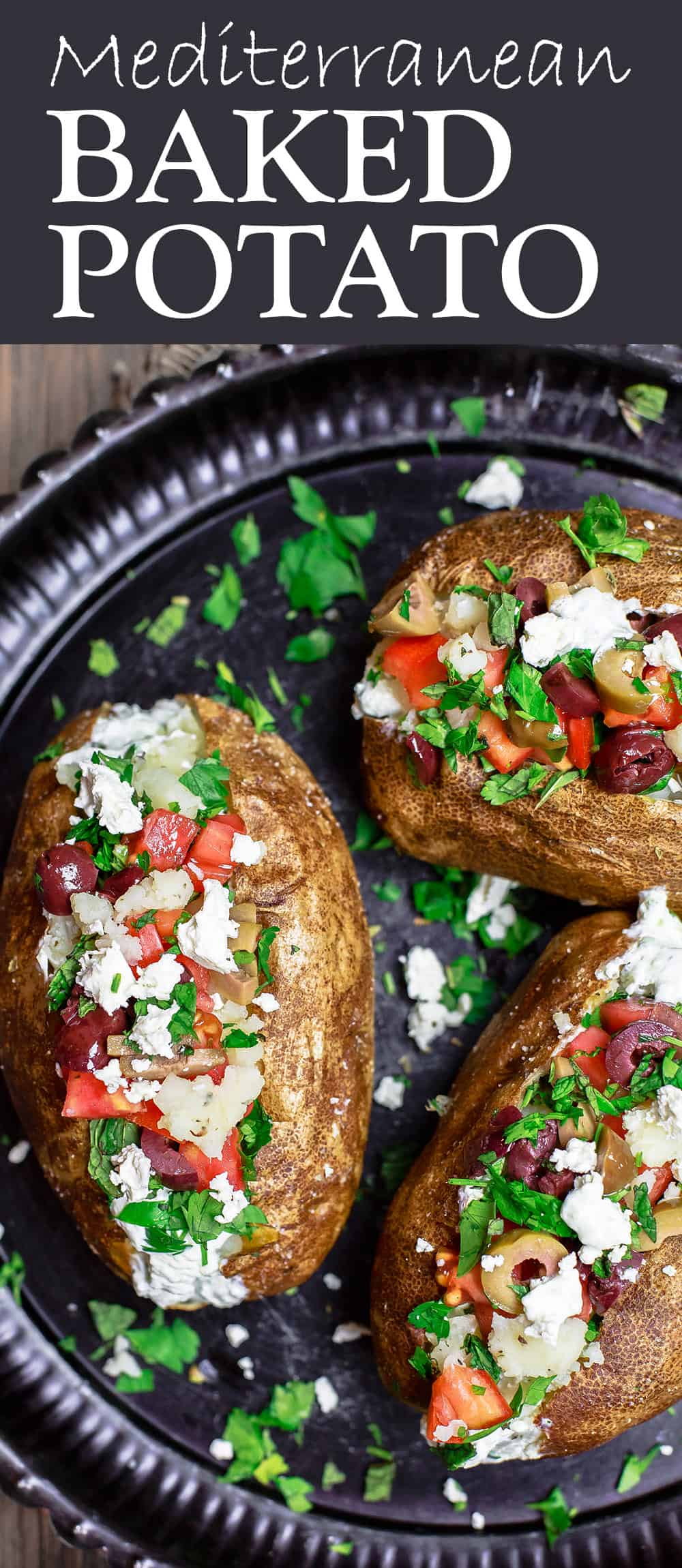 Mediterranean Loaded Baked Potato Recipe | The Mediterranean Dish. Crispy skinned baked potato, so creamy and fluffy on the inside. Topped with Tzatziki sauce, tomatoes, feta, olives and more. A healthier loaded baked potato with tons for flavor! Get the easy recipe on TheMediterraneanDish.com