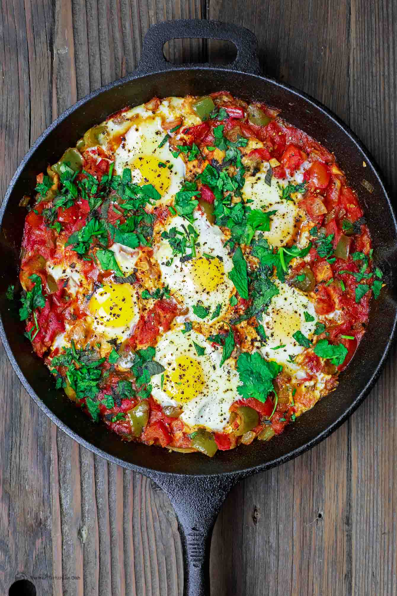 Shakshuka eggs in cast iron skillet