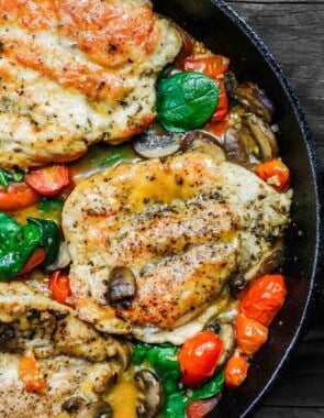 30-Minute Italian Skillet Chicken Recipe with Tomatoes and Mushrooms | The Mediterranean Dish. Flavor packed chicken breasts cooked in white wine with mushrooms, tomatoes and more! The perfect weeknight dinner in minutes! See the recipe on TheMediterraneanDish.com