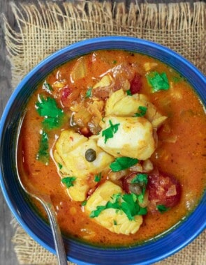 Sicilian Fish Stew Recipe | The Mediterranean Dish. Italian comfort in a bowl! My favorite! Fish fillet pieces cooked in a white wine and tomato broth with garlic, capers and more! Super easy and quick recipe. See it on TheMediterraneanDish.com