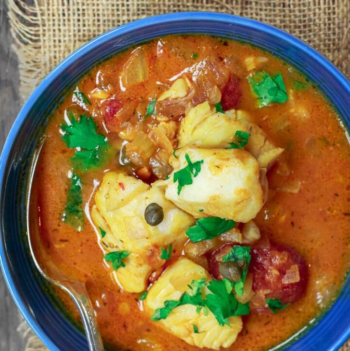 Sicilian Fish Stew Recipe | The Mediterranean Dish. Italian comfort in a bowl! My favorite! Fish fillet pieces cooked in a white wine and tomato broth with garlic, capers and more! Super easy and quick recipe. See it on TheMediterraneanDish.com