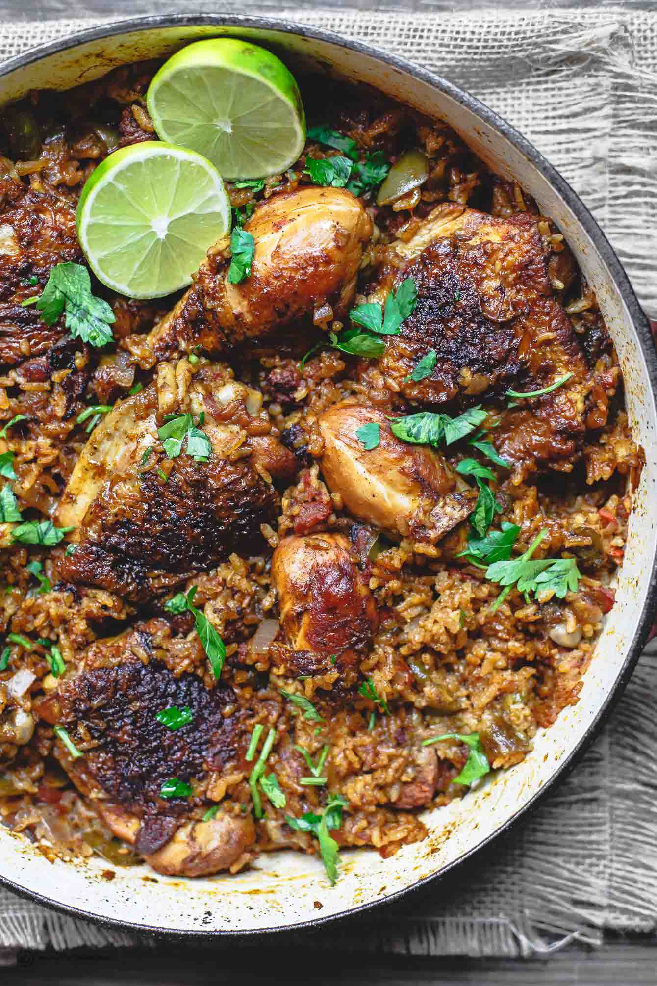 Bowl of Chicken and Rice served with lime halves