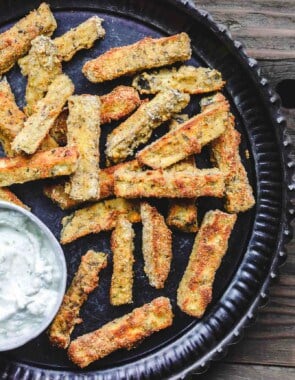 Baked Eggplant Fries with Greek Tzatziki Sauce | The Mediterranean Dish. Quick, simple and addictive! These eggplant fries are crispy on the outside, super tender and velvety on the inside. Served with Greek tzatziki sauce. See the easy recipe on TheMediterraneanDish.com