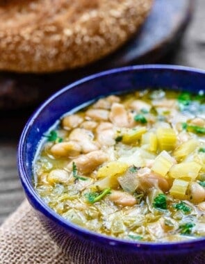 Easy Greek Bean Soup (Fasolada) | The Mediterranean Dish. Simple, flavor-packed Greek soup with white beans, celery, Mediterranean spices and aromatics. A satisfying weeknight dinner for a family on a budget! See the recipe on TheMediterraneanDish.com