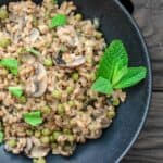 One-Pan Farro Recipe with Mushrooms and Peas | The Mediterranean Dish. This is my family's favorite farro recipe! Easy and tasty farro recipe made Mediterranean-style with mushrooms, peas, green onions, garlic, fresh herbs and more! So little work too! See the recipe on TheMediterraneanDish.com