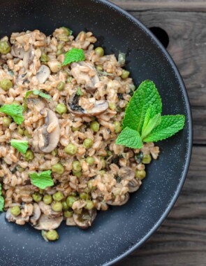 One-Pan Farro Recipe with Mushrooms and Peas | The Mediterranean Dish. This is my family's favorite farro recipe! Easy and tasty farro recipe made Mediterranean-style with mushrooms, peas, green onions, garlic, fresh herbs and more! So little work too! See the recipe on TheMediterraneanDish.com