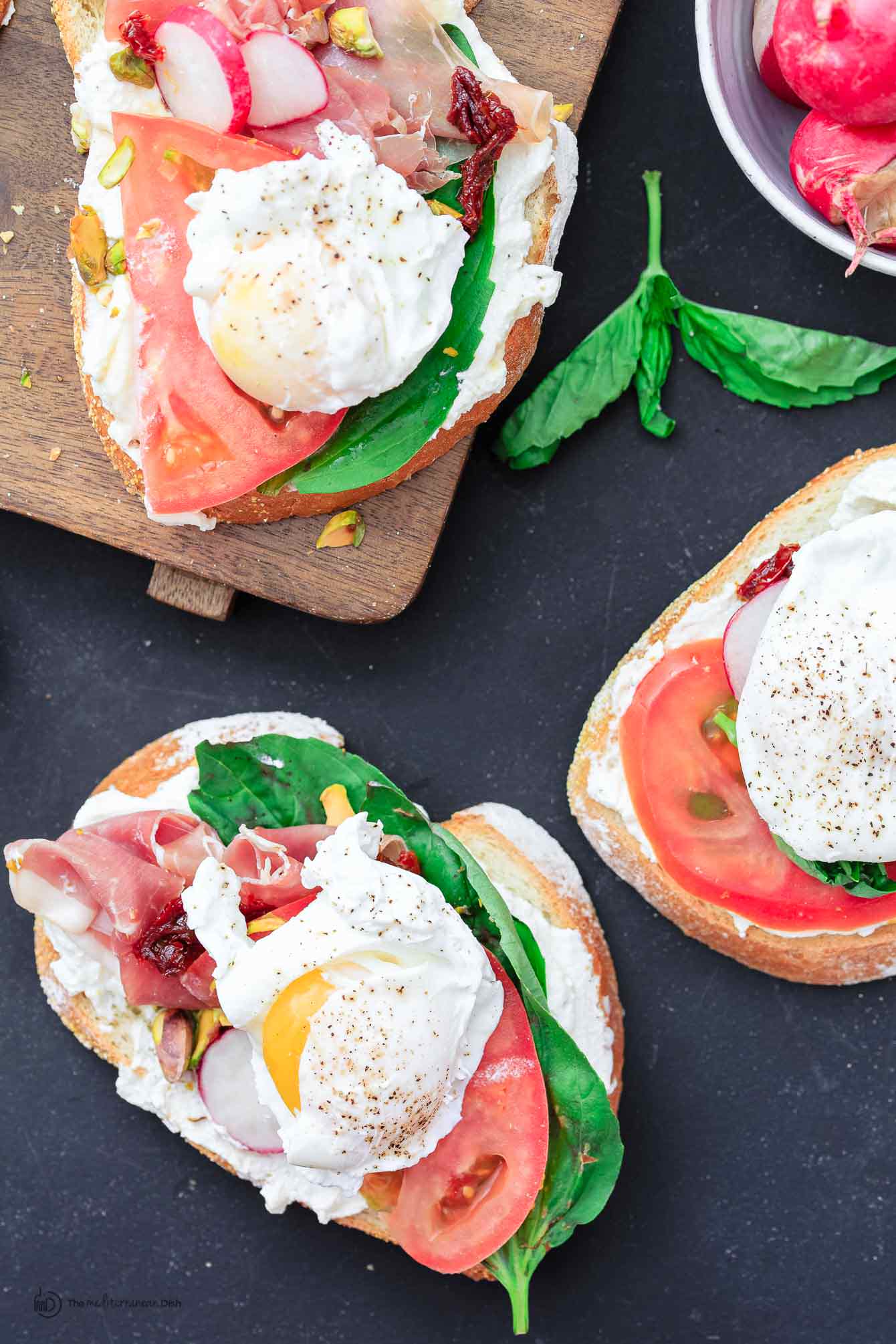 Poached eggs on top of Italian sandwiches