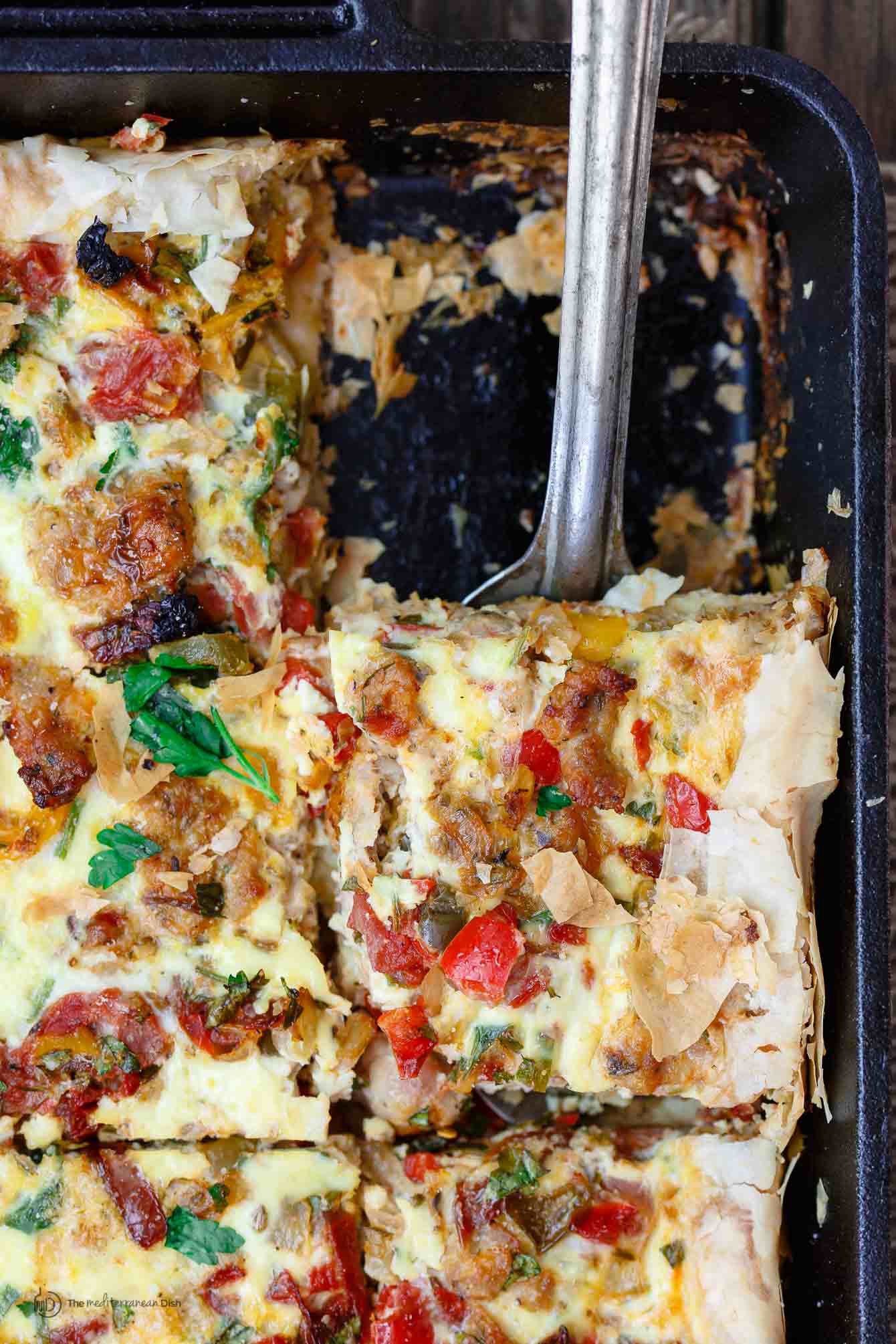 Baking dish containing strata with one piece removed