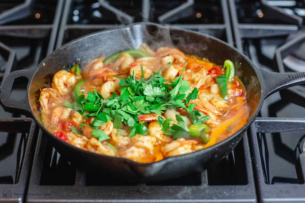 tomatoes and liquid is added to make the sauce. Parsley garnish added at the end