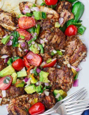 Persian-Style Barbecue Chicken Thighs Recipe | The Mediterranean Dish. Quick recipe for flavor-packed, tender chicken with Persian flavors. No waiting with this marinade! Top the chicken with our easy tomato avocado salad! See the full recipe on TheMediterraneanDish.com