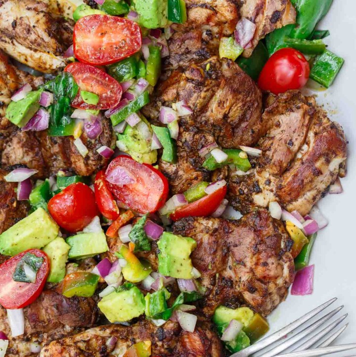 Persian-Style Barbecue Chicken Thighs Recipe | The Mediterranean Dish. Quick recipe for flavor-packed, tender chicken with Persian flavors. No waiting with this marinade! Top the chicken with our easy tomato avocado salad! See the full recipe on TheMediterraneanDish.com
