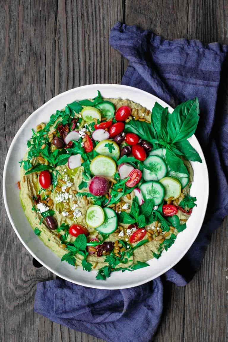 Mediterranean Farmer's Market Hummus Dip | The Mediterranean Dish. Easy, BIG hummus dip! Ready in like 10 minutes! Show-stopping hummus loaded with Mediterranean favorites: Fresh herbs and greens, veggies, feta, olives, sun-dried tomatoes…Get the recipe on TheMediterraneanDish.com