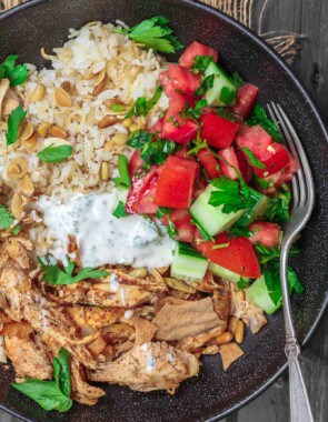 Lebanese Chicken Fatteh Dinner Bowls | The Mediterranean Dish. Flavor-packed Lebanese chicken recipe with toasted pita, rice and a simple Mediterranean salad all in one bowl. Check out the full recipe on TheMediterraneanDish.com