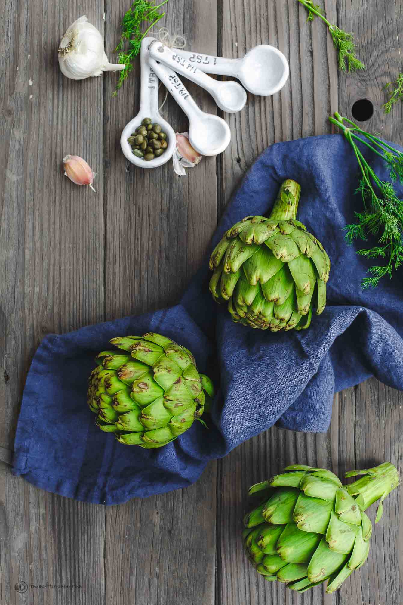 green artichoke globes  on a cloth