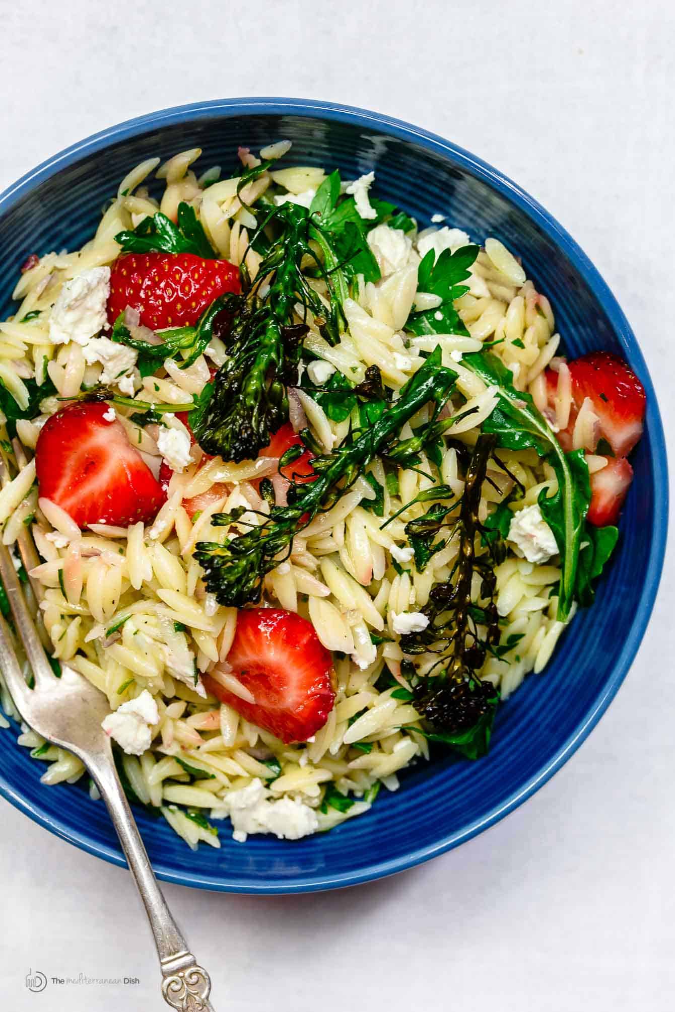 Close-up of orzo salad with strawberries and feta cheese