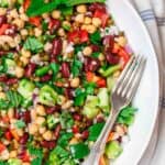 Mediterranean style three bean salad with bell peppers, fresh herbs, capers, and dijon viniagrette