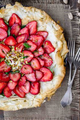 Feta Strawberry Tart with Fillo Crust | The Mediterranean Dish. A gorgeous sweet and savory strawberry tart with feta cheese, pistachio, basil and balsamic reduction! The flaky fillo (phyllo) crust takes it to a whole level of tasty! Easy recipe with step-by-step tutorial from TheMediterraneanDish.com
