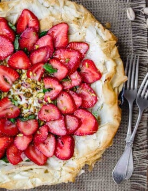 Feta Strawberry Tart with Fillo Crust | The Mediterranean Dish. A gorgeous sweet and savory strawberry tart with feta cheese, pistachio, basil and balsamic reduction! The flaky fillo (phyllo) crust takes it to a whole level of tasty! Easy recipe with step-by-step tutorial from TheMediterraneanDish.com