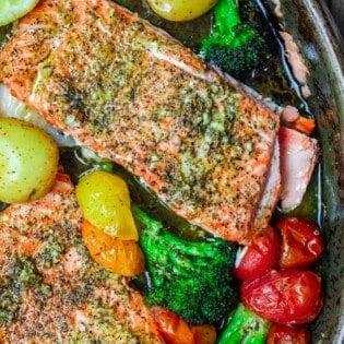 Za'atar Garlic Salmon Recipe | The Mediterranean Dish. Pan sheet garlic salmon with a Mediterranean twist you will love! Crusty za'atar, lemon juice, olive oil and veggies all on one sheet. Ready in 25 minutes! See the recipe on TheMediterraneanDish.com