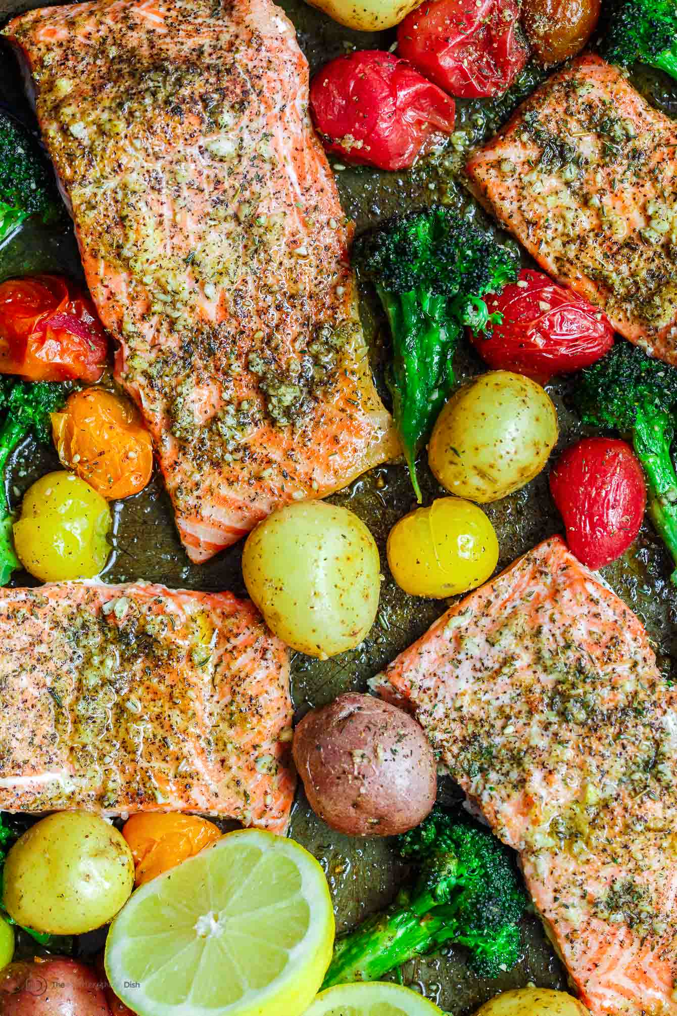 Za'atar garlic salmon in a pan with potatoes, broccoli and colorful grape tomatoes